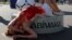 RUSSIA -- An activist attends a protest against torture, next to the World Cup mascot Zabivaka, outside the Saint Petersburg stadium in St. Petersburg, Russia July 3, 2018