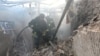 Ukrainian rescuers work at the site of a drone attack in Kharkiv on October 22, 2025, amid the Russian invasion of Ukraine.